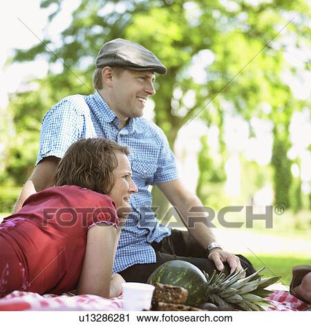 Couple having picnic together View Large Photo Image Stock Image - Couple having picnic together. Fotosearch