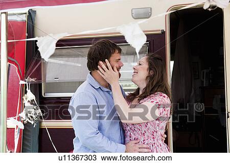 Couple hugging outside trailer View Large Photo Image Stock Image - Couple hugging outside trailer. Fotosearch