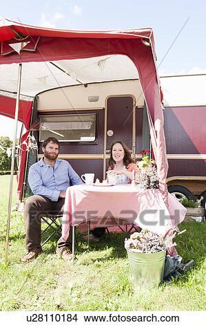 Couple picnicking outside trailer View Large Photo Image Picture - Couple picnicking outside trailer. Fotosearch
