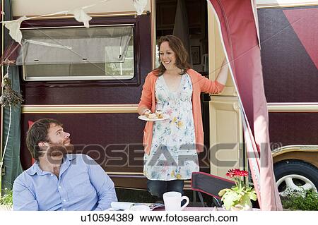 Couple picnicking outside trailer View Large Photo Image Stock Photo - Couple picnicking outside trailer. Fotosearch