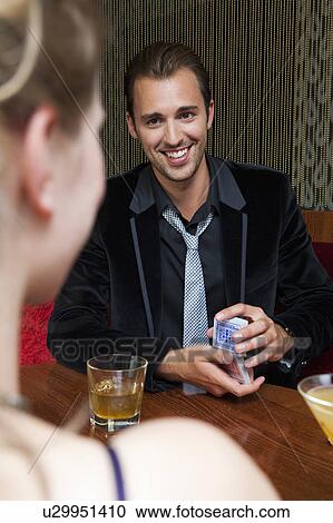 Couple playing cards in bar View Large Photo Image Stock Image - Couple playing cards in bar. Fotosearch