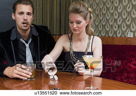 Couple playing dice in bar View Large Photo Image Stock Image - Couple playing dice in bar. Fotosearch