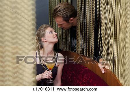 Couple talking through curtain in bar View Large Photo Image Stock Image - Couple talking through curtain in bar. Fotosearch