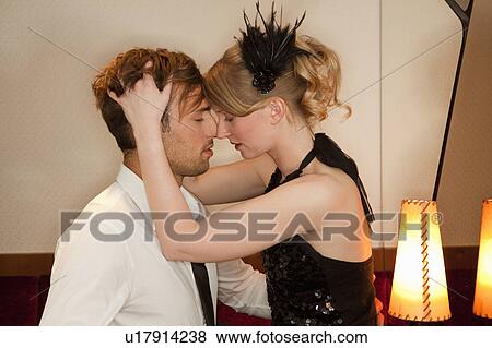 Stock Photo - Couple touching noses in bar. Fotosearch