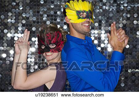 Couples wearing feather masks in bar View Large Photo Image Stock Image - Couples wearing feather masks in bar. Fotosearch