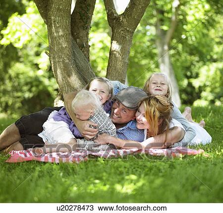 Stock Image - Family having picnic together. Fotosearch
