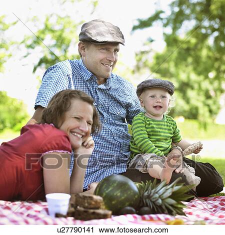 Stock Image - Family having picnic together. Fotosearch