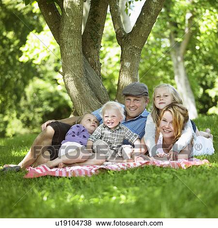 Family having picnic together View Large Photo Image Stock Photo - Family having picnic together. Fotosearch