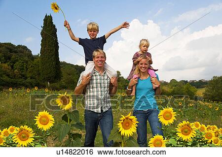 Family walking in field of flowers View Large Photo Image Stock Photograph - Family walking in field of flowers. Fotosearch
