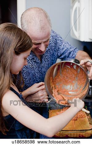 Stock Photo - Father and daughter cooking together. Fotosearch