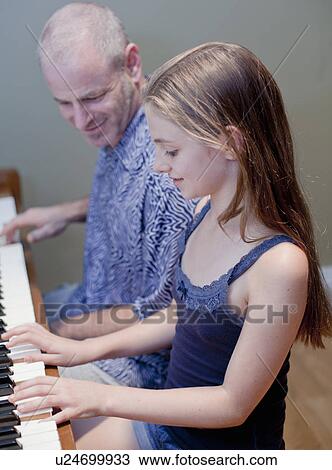 Father and daughter playing piano View Large Photo Image Stock Image - Father and daughter playing piano. Fotosearch