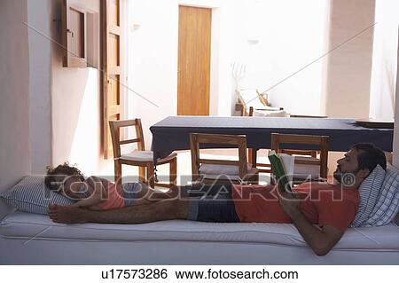 Father and daughter relaxing on sofa View Large Photo Image Stock Photograph - Father and daughter relaxing on sofa. Fotosearch