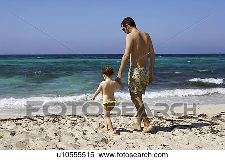 Father and daughter walking on beach View Large Photo Image Stock Photography - Father and daughter walking on beach. Fotosearch