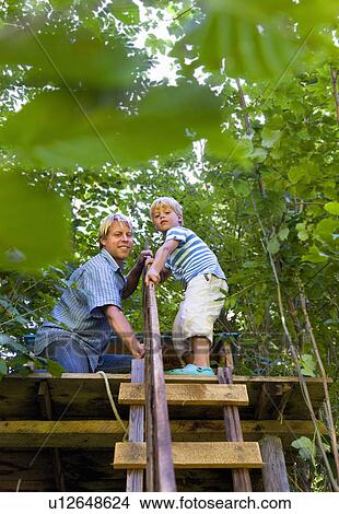 Father and son building treehouse View Large Photo Image Picture - Father and son building treehouse. Fotosearch