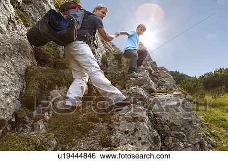 Father and son hiking on rocky terrain View Large Photo Image Stock Photograph - Father and son hiking on rocky terrain. Fotosearch