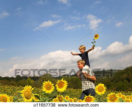 Father and son in field of flowers View Large Photo Image Stock Photo - Father and son in field of flowers. Fotosearch