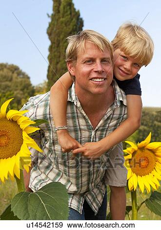 Father and son in field of flowers View Large Photo Image Stock Photo - Father and son in field of flowers. Fotosearch
