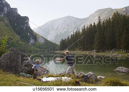 Father and son pitching a tent by lake View Large Photo Image Stock Image - Father and son pitching a tent by lake. Fotosearch