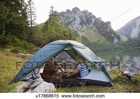 Father and son relaxing in tent View Large Photo Image Stock Photography - Father and son relaxing in tent. Fotosearch