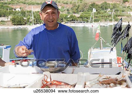 Fisherman selling fresh fish View Large Photo Image Picture - Fisherman selling fresh fish. Fotosearch