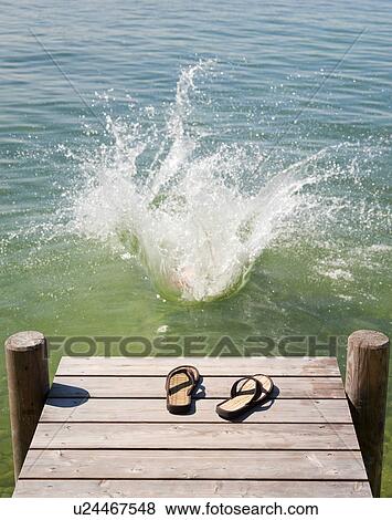 Flip flops on wooden deck by lake View Large Photo Image Stock Photo - Flip flops on wooden deck by lake. Fotosearch