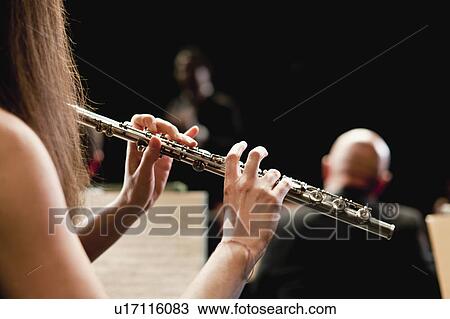 Flute player in orchestra View Large Photo Image Stock Image - Flute player in orchestra. Fotosearch