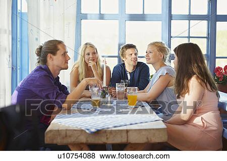 Friends drinking beer in restaurant View Large Photo Image Stock Photo - Friends drinking beer in restaurant. Fotosearch