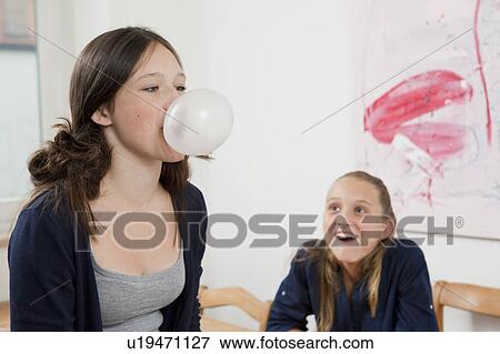 Girl blowing bubble with gum View Large Photo Image Stock Photo - Girl blowing bubble with gum. Fotosearch