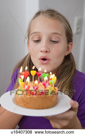 Girl blowing out birthday candles View Large Photo Image Stock Photo - Girl blowing out birthday candles. Fotosearch