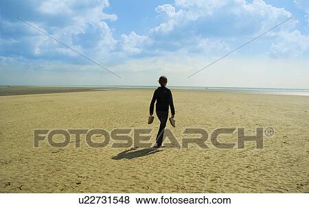 Girl carrying shoes on beach View Large Photo Image Stock Photo - Girl carrying shoes on beach. Fotosearch