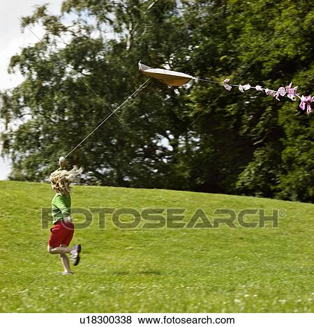 Girl flying kite in field View Large Photo Image Stock Photo - Girl flying kite in field. Fotosearch