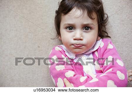 Picture - Girl laying on carpet. Fotosearch