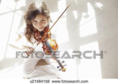Girl playing violin on carpet View Large Photo Image Stock Photo - Girl playing violin on carpet. Fotosearch