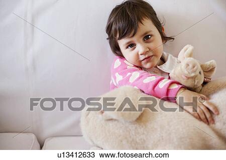 Girl playing with stuffed animal View Large Photo Image Stock Image - Girl playing with stuffed animal. Fotosearch