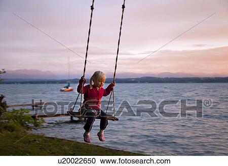 Girl swinging by lake View Large Photo Image Stock Image - Girl swinging by lake. Fotosearch