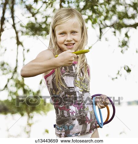 Girl throwing rings outdoors View Large Photo Image Stock Photo - Girl throwing rings outdoors. Fotosearch