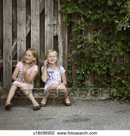 Girls listening to mp3 players together View Large Photo Image Stock Image - Girls listening to mp3 players together. Fotosearch