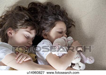Stock Photo - Girls napping on carpet together. Fotosearch