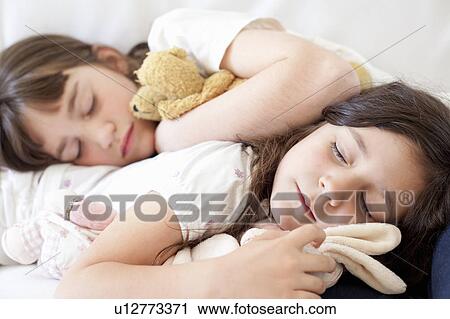 Girls napping on couch together View Large Photo Image Stock Image - Girls napping on couch together. Fotosearch