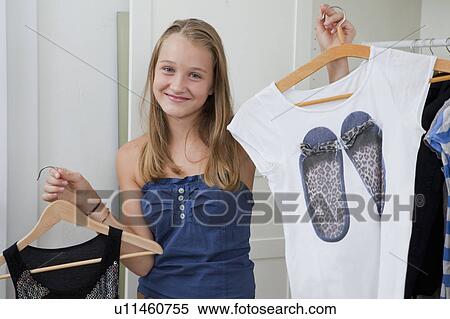 Girls picking outfits in bedroom View Large Photo Image Stock Photography - Girls picking outfits in bedroom. Fotosearch