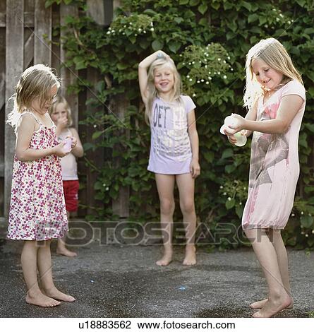 Girls playing together on concrete View Large Photo Image Stock Image - Girls playing together on concrete. Fotosearch