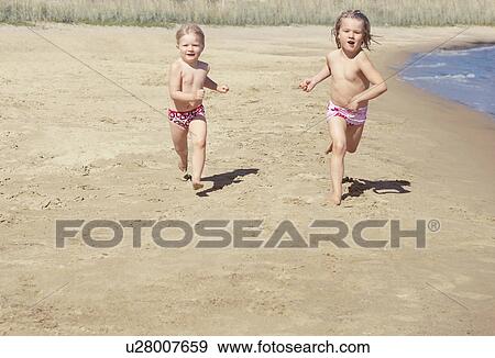 Stock Photo - Girls running on beach. Fotosearch