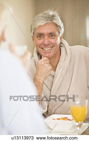 Man having breakfast with wife View Large Photo Image Stock Image - Man having breakfast with wife. Fotosearch