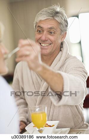 Man having breakfast with wife View Large Photo Image Stock Photograph - Man having breakfast with wife. Fotosearch