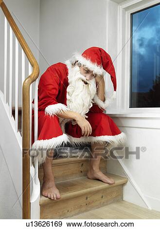 Man in Santa Claus suit sitting on steps View Large Photo Image Stock Photo - Man in Santa Claus suit sitting on steps. Fotosearch