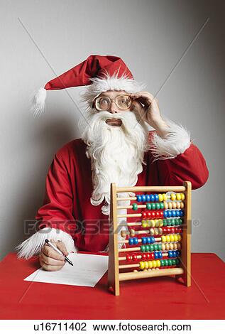 Man in Santa Claus suit using abacus View Large Photo Image Stock Image - Man in Santa Claus suit using abacus. Fotosearch