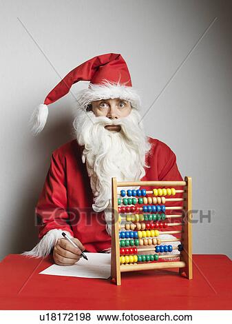 Man in Santa Claus suit using abacus View Large Photo Image Stock Photo - Man in Santa Claus suit using abacus. Fotosearch