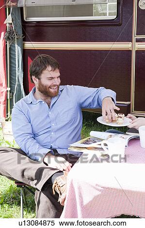 Man picnicking outside trailer View Large Photo Image Stock Photography - Man picnicking outside trailer. Fotosearch