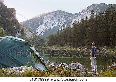 Man relaxing at campsite View Large Photo Image Stock Photo - Man relaxing at campsite. Fotosearch