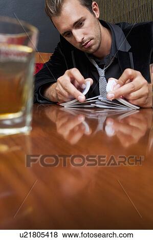 Man shuffling cards in bar View Large Photo Image Stock Photo - Man shuffling cards in bar. Fotosearch
